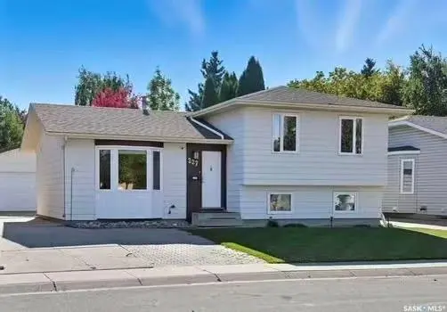 Exterior photo of 227 Waterbury Road, Saskatoon, SK, showing a charming updated 3-bedroom split-level home.